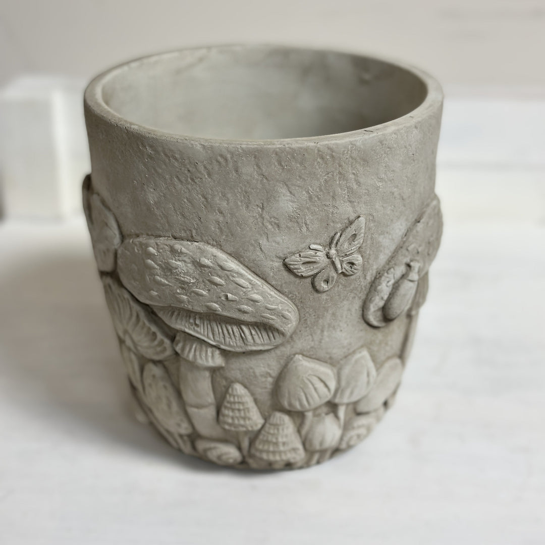 Small stone-colored woodland planter viewed from the front