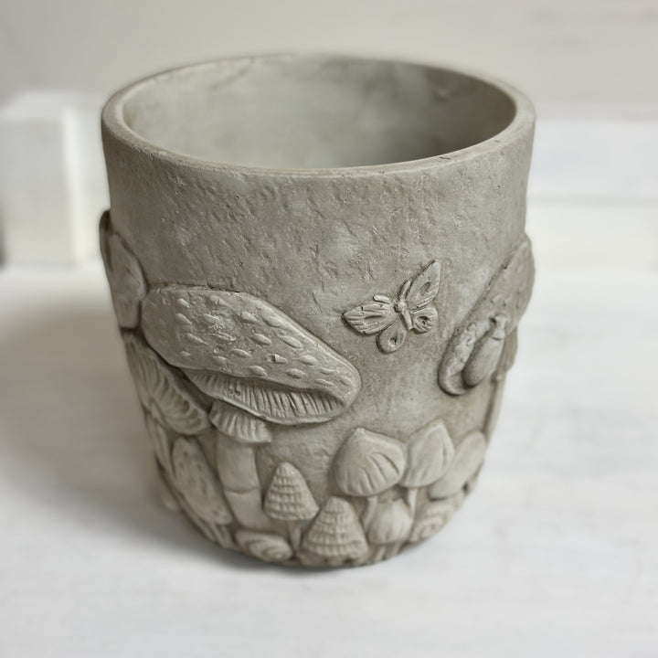 Small stone-colored woodland planter viewed from the front