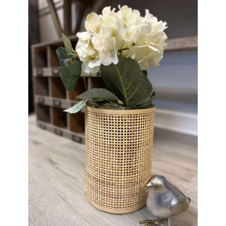 Tall rattan glass vase styled with white hydrangea