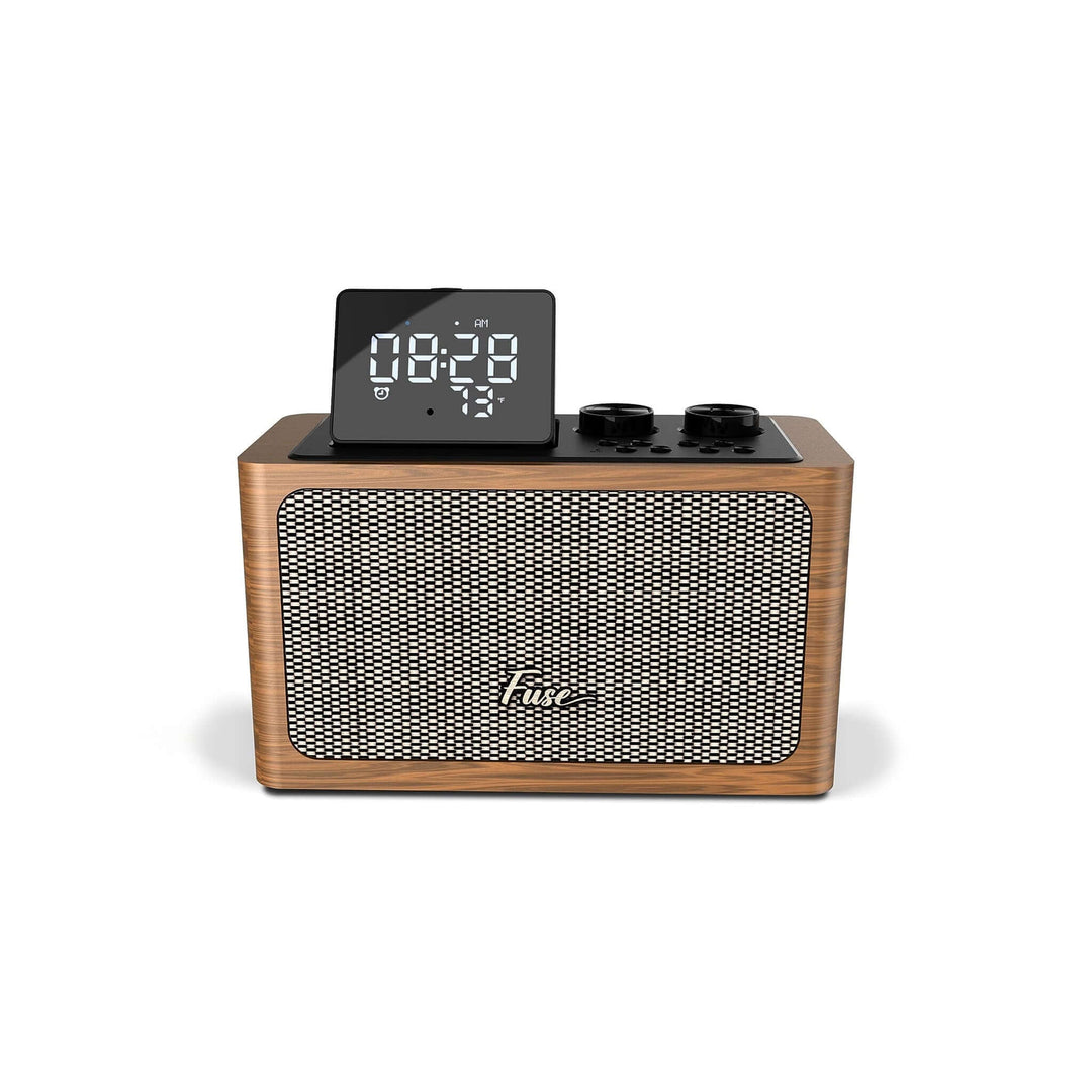 Wooden clock radio with digital display on a white background
